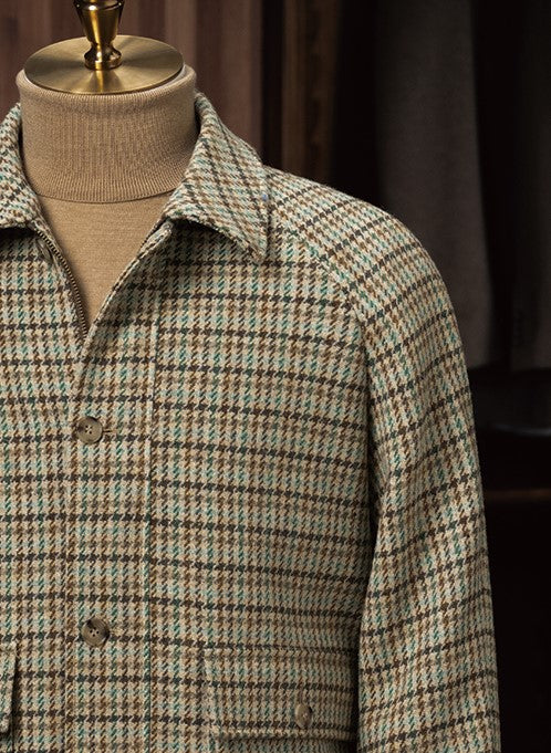 Close-up of a checked field jacket showcasing fine tailoring, a classic collar, and eco-friendly fabric in a textured pattern, ideal for high-end formal wear.
