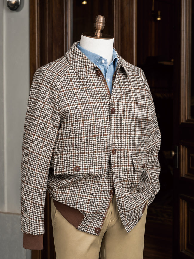 Close-up of a tailored houndstooth sports coat paired with chinos, showcasing sustainable fabric and fine detailing, ideal for formal and eco-conscious style.