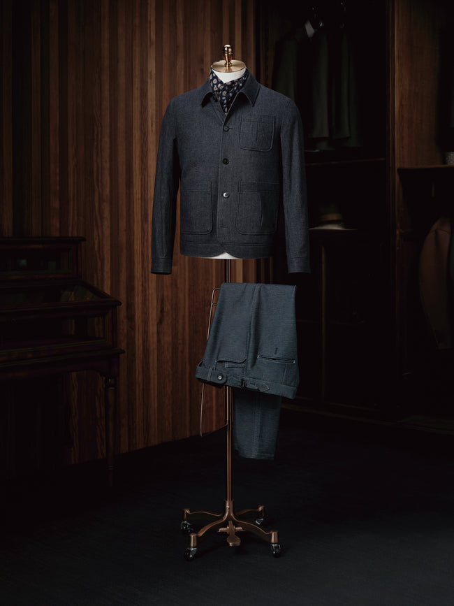 A sophisticated navy wool overshirt paired with navy trousers, perfect for a seamless and elegant look.