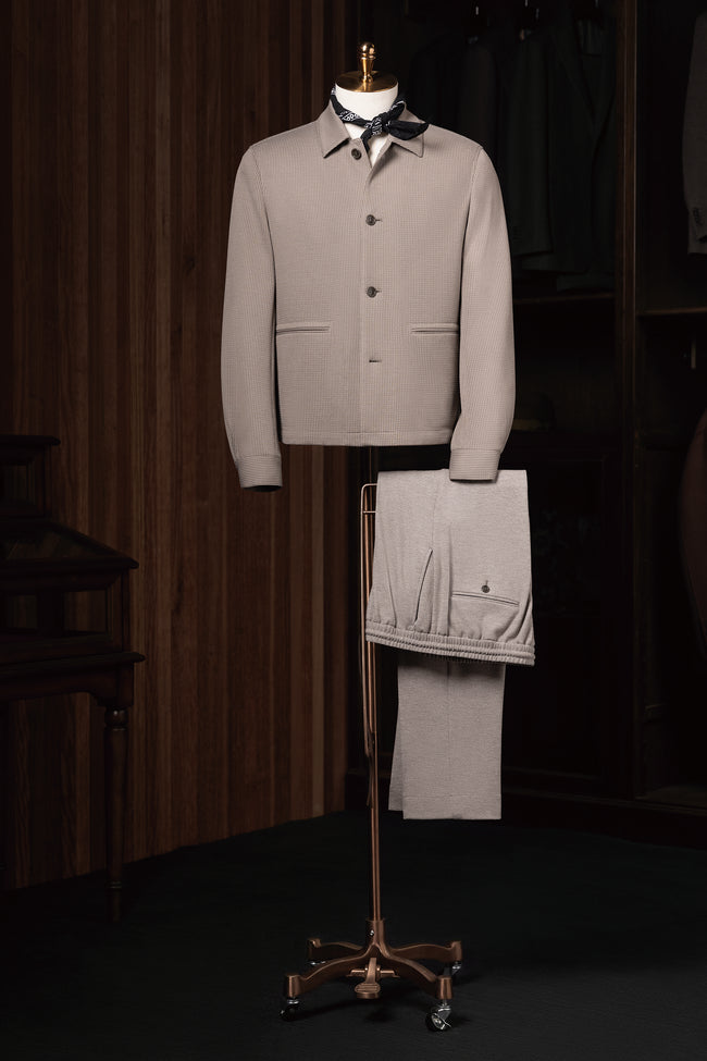 Full view of stone grey matching jacket and trousers ensemble displayed on mannequin stand, ideal for smart casual menswear styling.