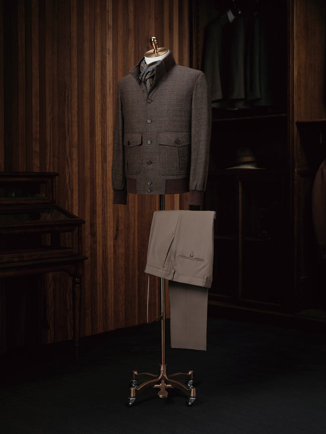 A stylish wool bomber jacket paired with khaki trousers, perfect for a modern casual look.