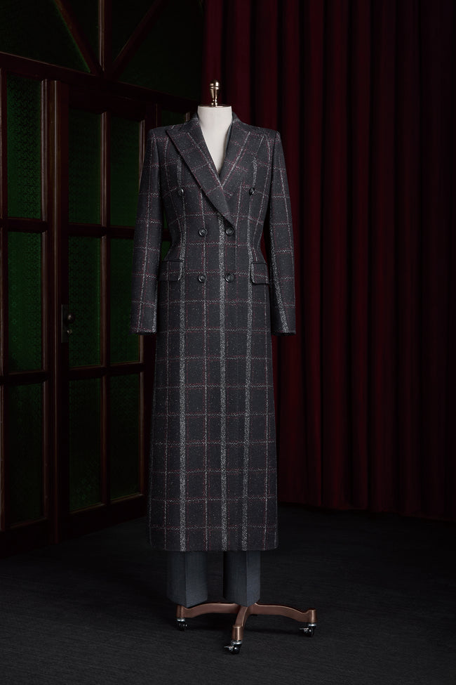 Women's double-breasted plaid overcoat in black, red, and white. Elegant formal wear crafted from sustainable materials, perfect for high-end style.