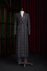 Women's double-breasted plaid overcoat in black, red, and white. Elegant formal wear crafted from sustainable materials, perfect for high-end style.