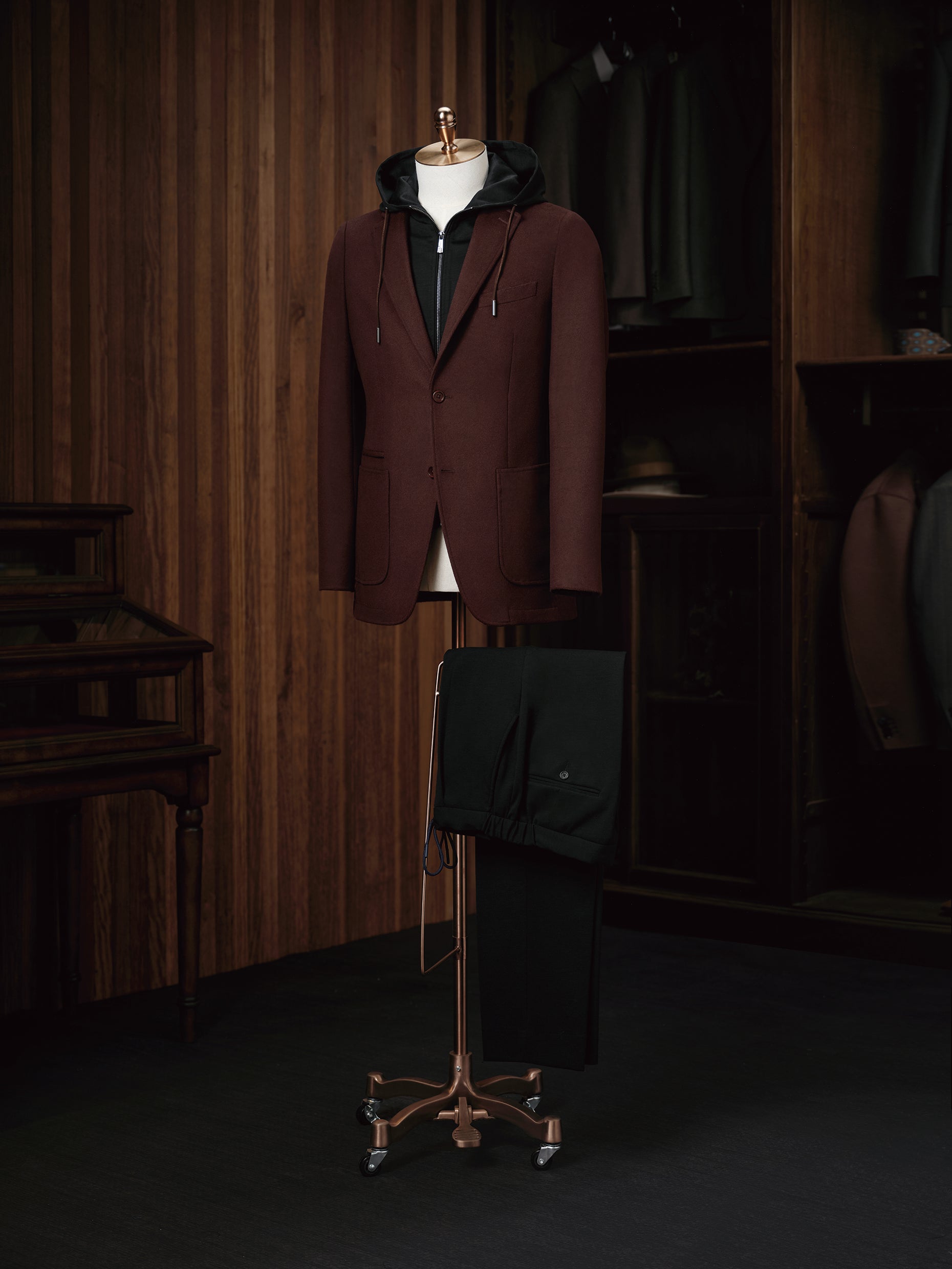 Men's burgundy casual blazer paired with black drawstring pants, elegantly styled with a black hoodie for a refined yet relaxed look. Ideal for fashion-forward individuals seeking a blend of sophistication and comfort. Crafted from sustainable materials for eco-conscious style.