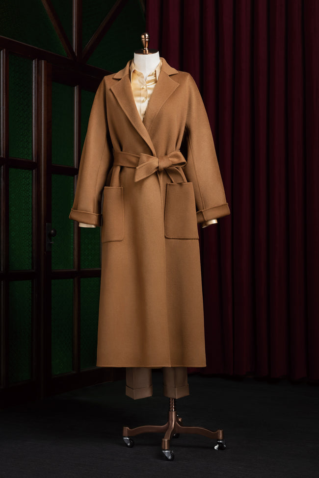 Elegant camel beige overcoat for women with tailored fit and belted waist, perfect for formal events. Sustainable, eco-friendly fashion in luxurious wool fabric.