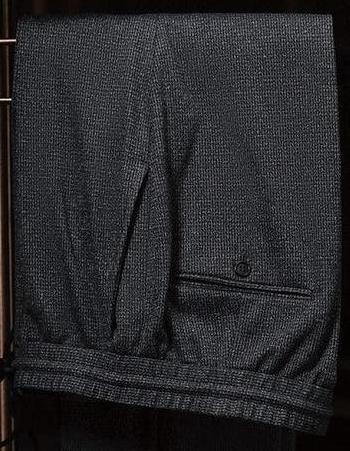 Close-up of charcoal grey suit trousers, showcasing fine textured fabric, precise tailoring, and back pocket detail, perfect for a sophisticated formal look.