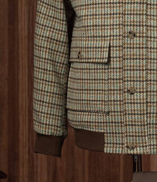 Close-up of a checked field jacket pocket and sleeve, highlighting eco-friendly tailored details and premium textured fabric, perfect for formal wear.