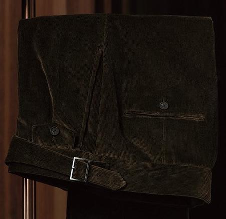 Close-up of brown corduroy trousers with belt detail, showcasing sustainable fabric and fine tailoring, perfect for an elegant, eco-friendly formal look.