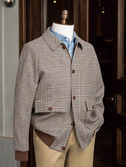 Close-up of a tailored houndstooth sports coat paired with chinos, showcasing sustainable fabric and fine detailing, ideal for formal and eco-conscious style.