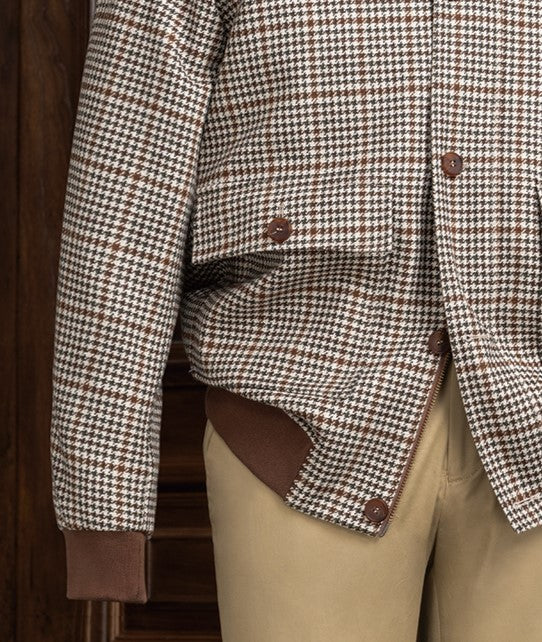 Close-up of houndstooth sports coat buttons and cuff with beige chinos, highlighting sustainable fabric, tailored detailing, and refined style for formal wear.