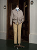 Full view of a tailored houndstooth sports coat paired with beige chinos on a mannequin, highlighting sustainable fashion and refined detailing for formal style