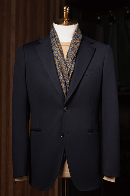 Close-up of a classic navy blazer with structured peak lapels and sleek pocket details. Perfect for a high-end, polished look for formal events.