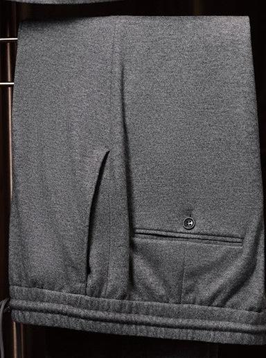 Close-up of wool suit trousers, showcasing fine textured fabric, precise tailoring, and back pocket detail, perfect for a sophisticated formal look.