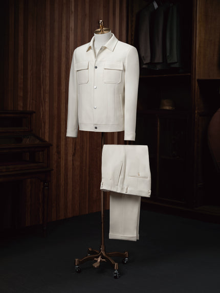 The Couturist's matching white tailored jacket and trousers ensemble on display. Premium women's formalwear featuring sustainable materials.