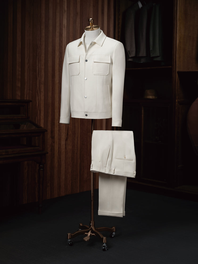 The Couturist's matching white tailored jacket and trousers ensemble on display. Premium women's formalwear featuring sustainable materials.