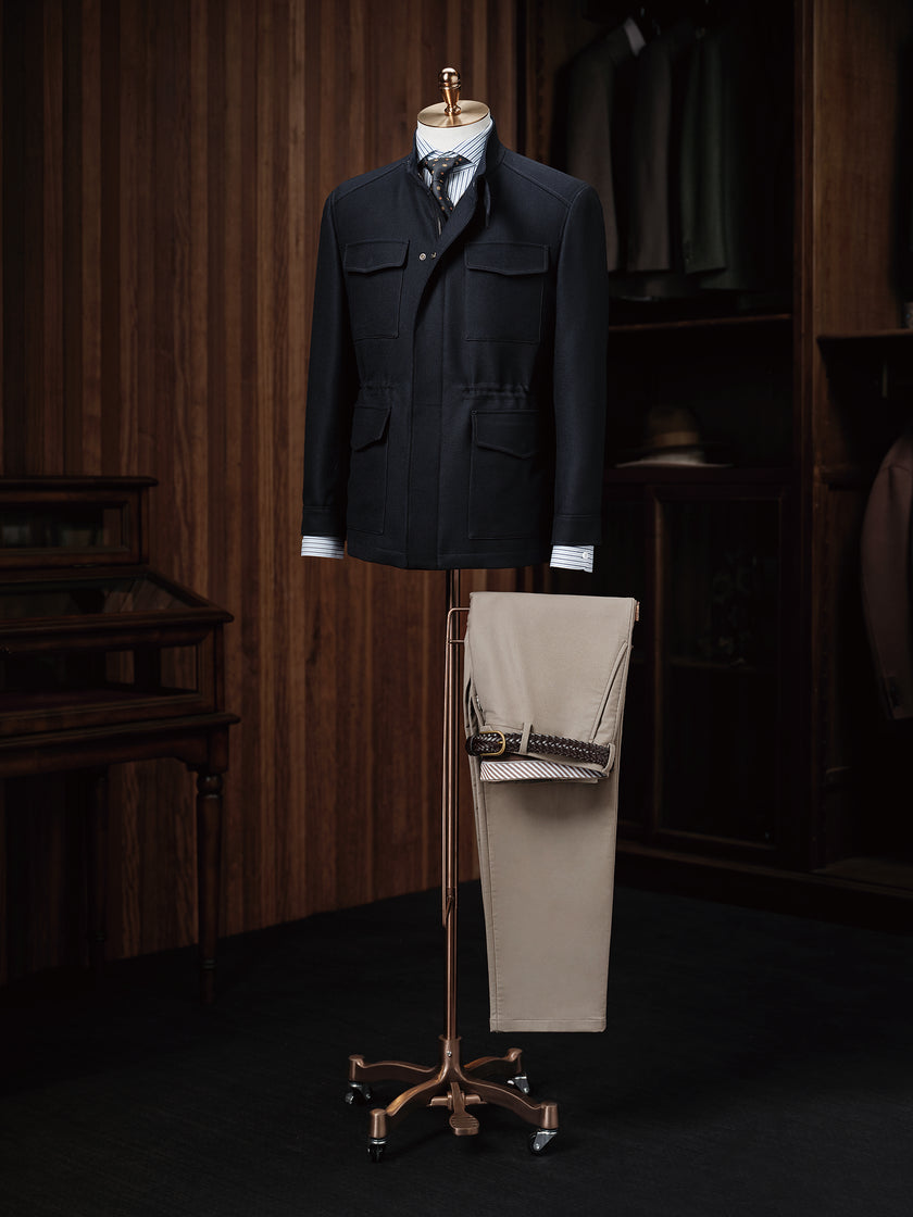 A versatile navy utility jacket paired with beige trousers, ideal for a smart casual look.