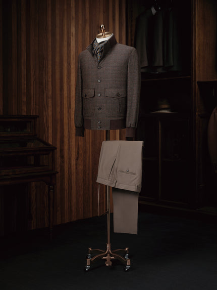 A stylish wool bomber jacket paired with khaki trousers, perfect for a modern casual look.
