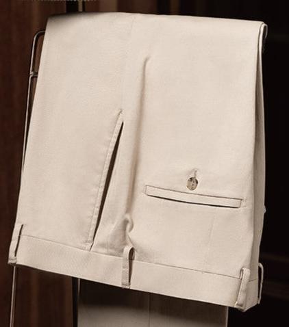 Close-up of beige tailored trousers with buttoned back pocket, cuffed hem, and subtle belt loops — ideal for spring and summer smart-casual looks.