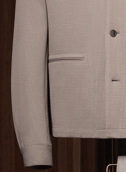 Zoomed-in view of the stone grey tailored jacket hem and sleeve cuff, showcasing the textured fabric and clean pocket seam.